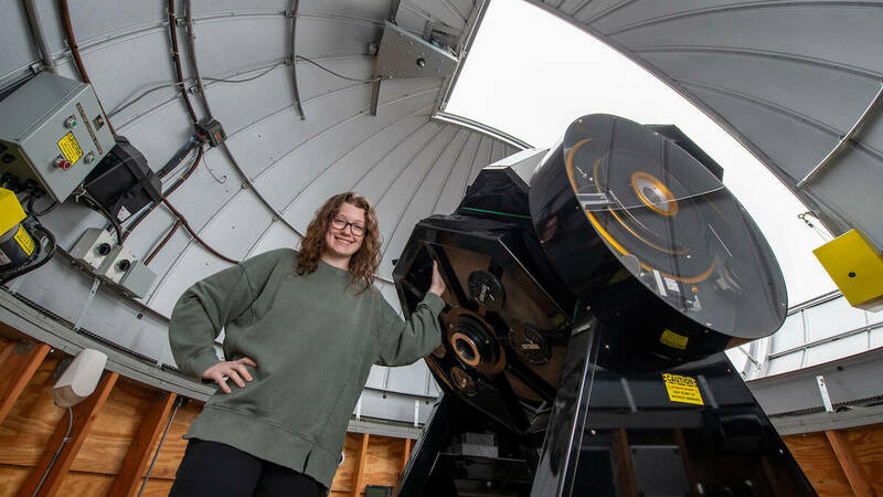Undergraduate student McKenna Leichty stands next to the Krizmanich telescope atop Jordan Hall of Science, University of Notre Dame