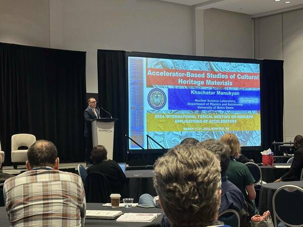 Dr. Manuykan delivering a plenary talk at the 2024 International Topical Meeting on Nuclear Applications of Accelerators .