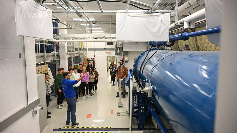 Graduate students in the Nuclear Science Laboratory at the University of Notre Dame Department of Physics & Astronomy looking at an accelerator